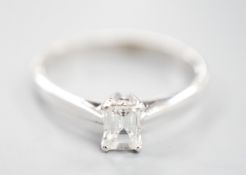 A modern 18ct white metal and solitaire emerald cut diamond set ring, size K, gross weight 2