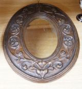 An Art Nouveau style moulded gesso oval mirror, 57cms high