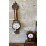 An Edwardian inlaid mahogany tear drop mantel clock, height 34cm and a carved oak aneroid wheel