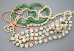 Two single strand cultured pearl necklaces, one with 9ct gold clasp, two green glass bangles, a