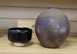 Japanese studio pottery: a boxed black glaze stoneware unomi tea bowl, with impressed mark, together