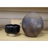 Japanese studio pottery: a boxed black glaze stoneware unomi tea bowl, with impressed mark, together