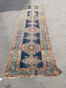 A North West Persian blue ground runner, (heavily worn) 404 x 101cm