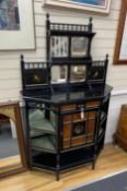 A late Victorian aesthetic movement ebonised and bird's eye maple mirror-back break front