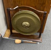 An early 20th century mahogany gong with striker on stand, height 67cm