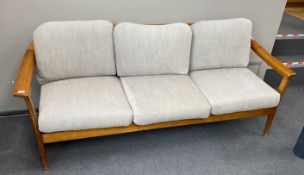 A mid century Wilhelm Knoll cherry three seater settee with loose cushion seats and backs.