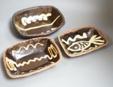 Winchcombe pottery, three press moulded slipware dishes, one with Ray Finch maker’s stamp, largest