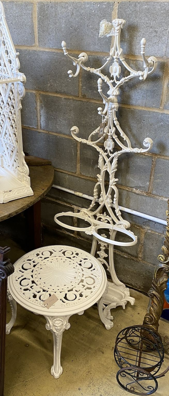 A Victorian cast iron hall stand, height 154cm, reduced and a later circular cast metal table (