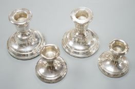 Two pairs of modern silver mounted dwarf candlesticks, tallest 84mm.