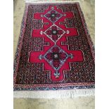 A North West Persian red ground rug, 112 x 74cm