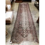 An antique Malayer red ground runner, approx. 260 x 99cm