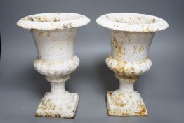 A pair of small white painted cast-iron campana urns, 25cms high