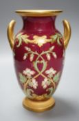 A 19th century English bone china two handled vase, decorated with a central cartouche, in