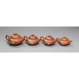 Four Chinese Yixing graduated enamelled miniature teapots, largest 5.5cms high