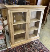 A Victorian and later pine glazed two door bookcase, length 113cm, depth 29cm, height 119cm