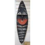 A Papua New Guinea Minja painted wood figure wall hanging in the form of a shield, 130cm tall