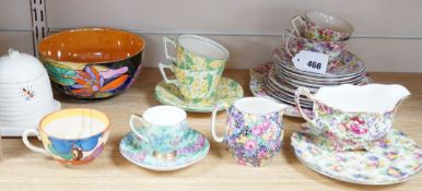A Clarice Cliff tea cup, a collection of chintz patterned teaware, a lustre bowl and a honey pot and