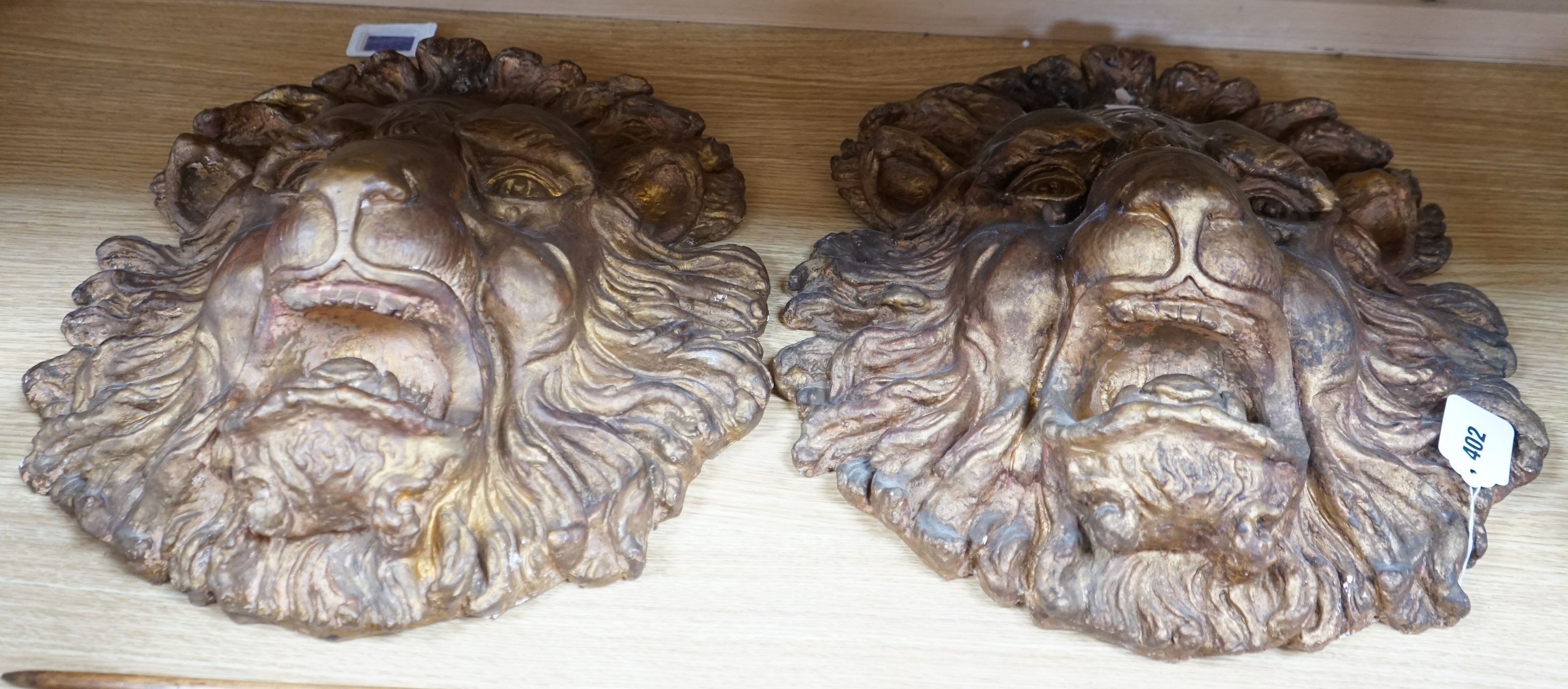 A pair of large decorative gilt plaster lion masks, 42cm