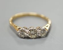 An 18ct gold and platinum three stone diamond ring, size M, gross 2.4 grams