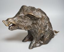A 20th century cast bronze model of a seated boar, numbered ‘14’, height 24cm
