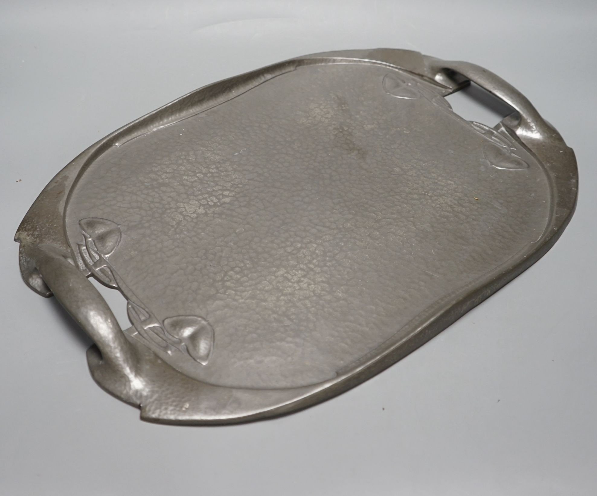 A Liberty's Tudric hammered pewter tray designed by A. Knox, 49cms wide