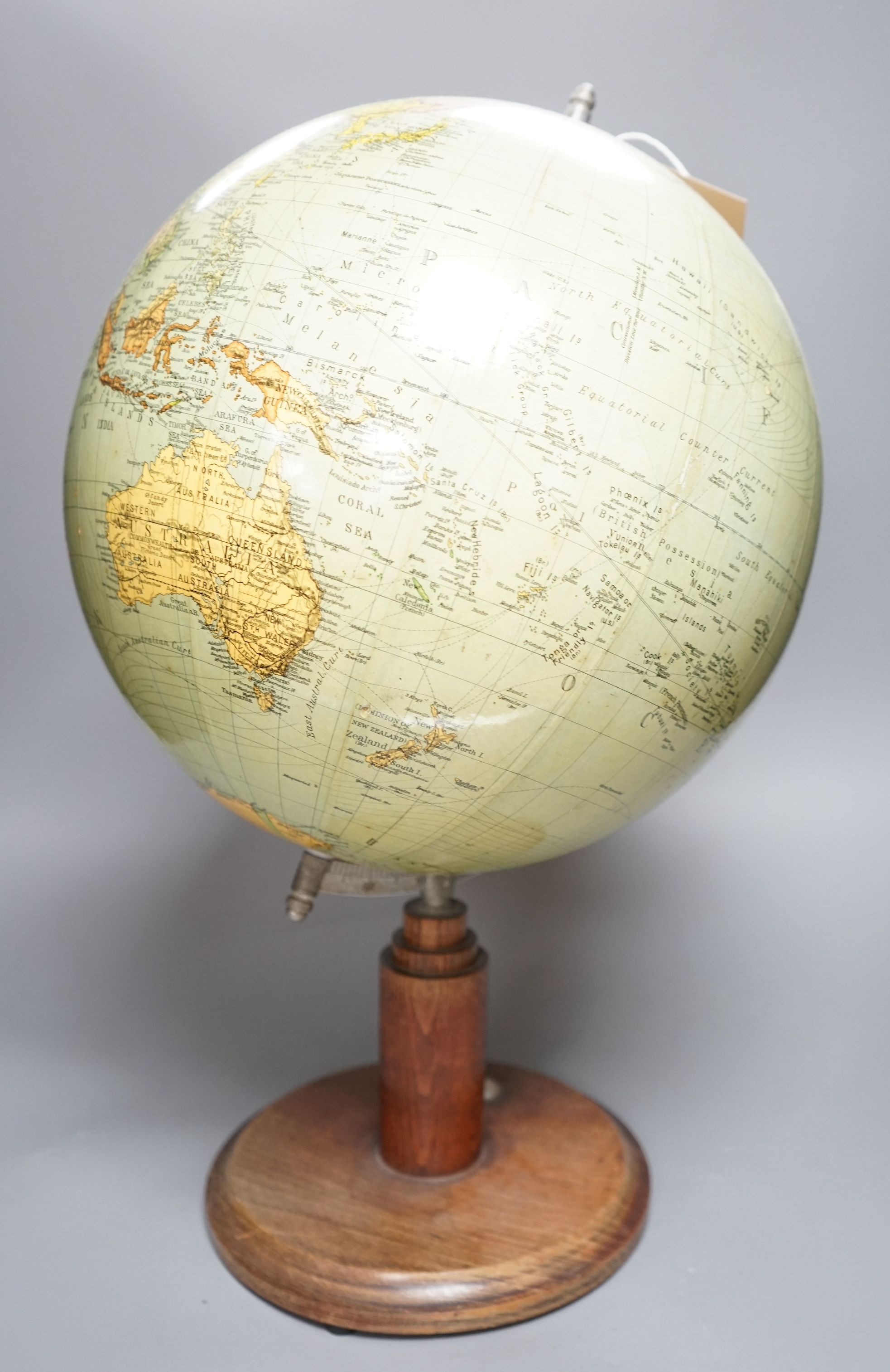 A mid 20th century globe on a revolving stand with an inset compass, 54cms high including stand