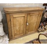 A Victorian pine two door side cabinet, with twin panelled doors, width 128cm, depth 34cm, height