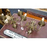 A pair of brass two branch sconces, 35cms high,