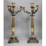 A pair of 19th century French Empire style bronze and gilt metal three branch, four light
