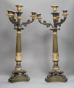 A pair of 19th century French Empire style bronze and gilt metal three branch, four light