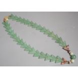 A Chinese jade arrowed pendant necklace