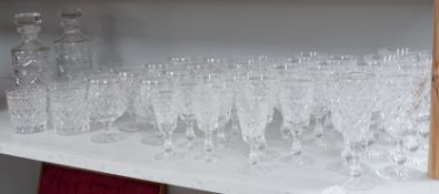 A quantity of Stuart cut glass suite of wine and spirit glasses and a similar pair of decanters