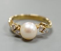 A 14kt yellow metal and single stone cultured pearl ring, with diamond set shoulders, size J,
