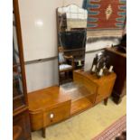 A 1960's mahogany mirrored dressing table, width 150cm, depth 38cm, height 154cm