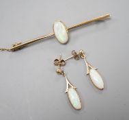 A 15ct and white opal set bar brooch, 60mm and a pair of yellow metal and white opal set drop