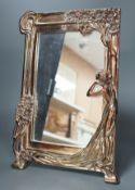 A silver plated Art Nouveau style mirrored frame, decorated with a female figure, tree and flowers