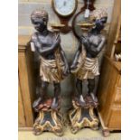 A pair of Italian carved wood Blackamoor torcheres, with a pair of six branch lights now detached,