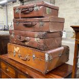 Four vintage suitcases, largest 82 x 53cm