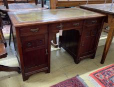A late Victorian Aesthetic movement oak kneehole writing table, width 120cm, depth 60cm, height