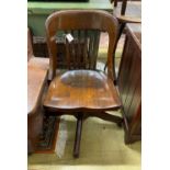 An early 20th century American walnut swivel desk chair, by the Marble and Shattuck Chair Co,