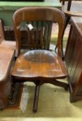An early 20th century American walnut swivel desk chair, by the Marble and Shattuck Chair Co,