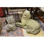 Two reconstituted stone garden ornaments, recumbent hound and seated cat, larger height 34cm