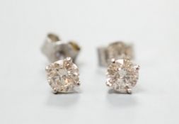 A pair of white metal and solitaire diamond set ear studs, gross weight 0.8 grams, stone diameter
