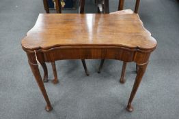 A George III mahogany concertina action folding games table, width 79cm, depth 40cm, height 72cm