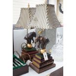 A pair of novelty table lamps: elephants balancing on balls on books, 63cms high,