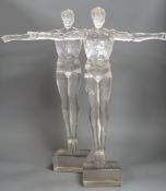 A pair of clear perspex models of male swimmers, 57cms high,