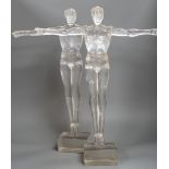 A pair of clear perspex models of male swimmers, 57cms high,