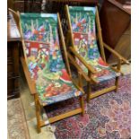 A pair of modern teak framed deck chairs with printed fabric panels