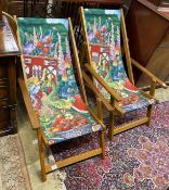 A pair of modern teak framed deck chairs with printed fabric panels