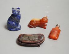 A Chinese carved lapis lazuli seated cat, a banded agate recumbent cat on hardwood stand and a white